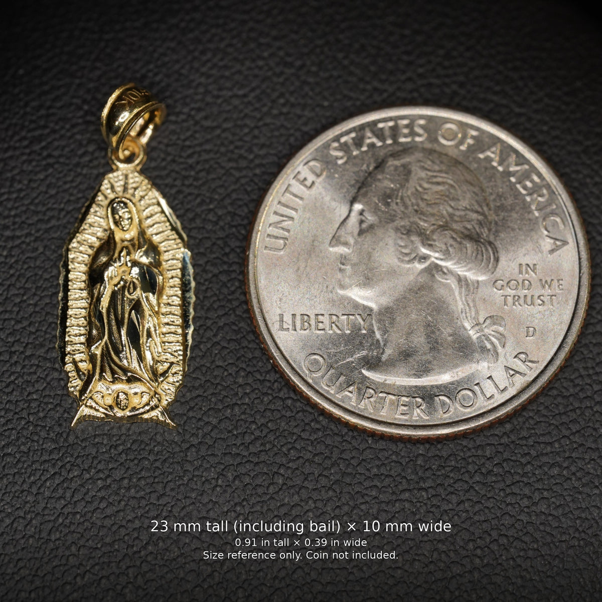 10K gold Virgin Mary pendant beside a U.S. quarter, with dimensions labeled 23 mm tall including bail by 10 mm wide. Size reference only; coin not included.